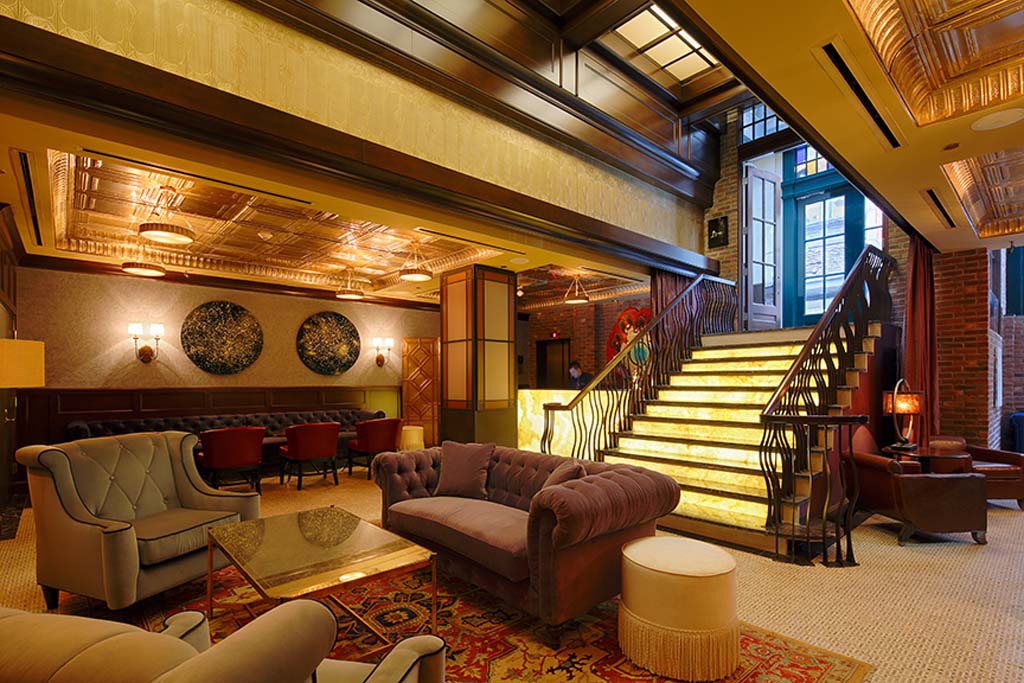 Luxurious lounge with vintage decor and an illuminated staircase.